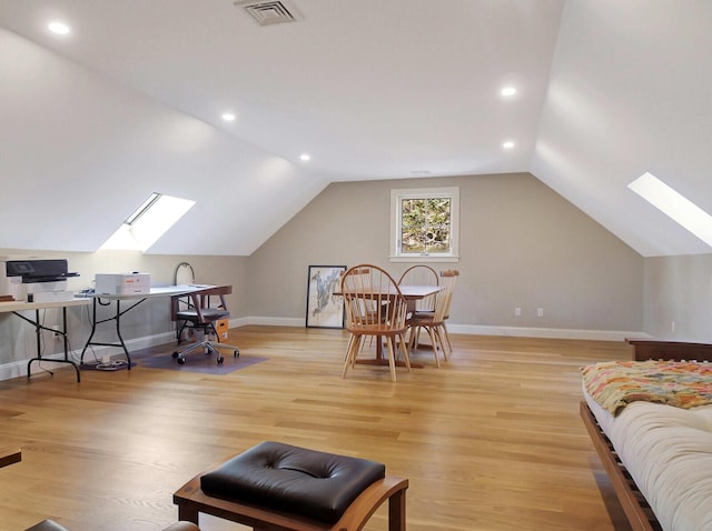 office space featuring a skylight, light wood-style flooring, vaulted ceiling, baseboards, and recessed lighting