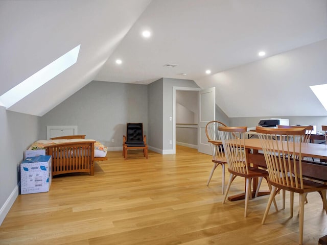 bedroom featuring a skylight, vaulted ceiling, light wood finished floors, recessed lighting, and baseboards