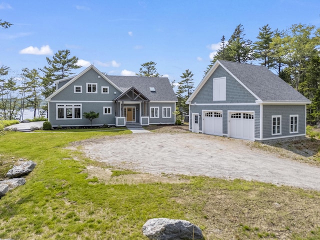 92 Brooks Cove Rd, Westport Island, ME 04578 - shingle-style home with a garage, a front lawn, and an outbuilding