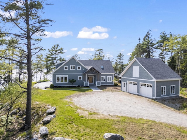 92 Brooks Cove Rd, Westport Island, ME 04578 - shingle-style home with an outdoor structure, a front yard, dirt driveway, and a detached garage