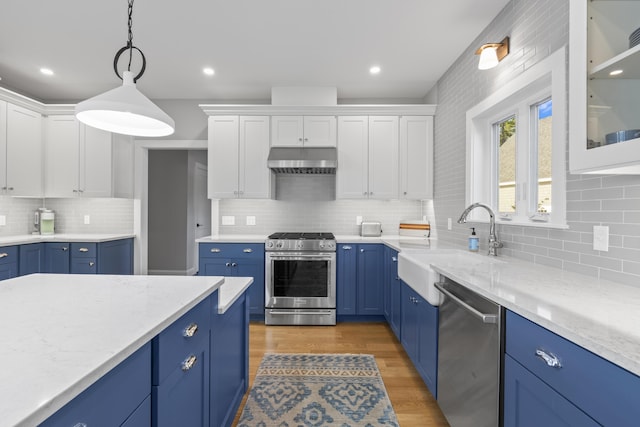 92 Brooks Cove Rd, Westport Island, ME 04578 - kitchen with stainless steel appliances, blue cabinets, backsplash, white cabinets, and recessed lighting