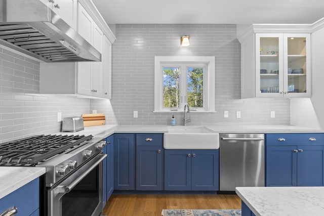 92 Brooks Cove Rd, Westport Island, ME 04578 - kitchen with appliances with stainless steel finishes, under cabinet range hood, blue cabinets, and white cabinetry