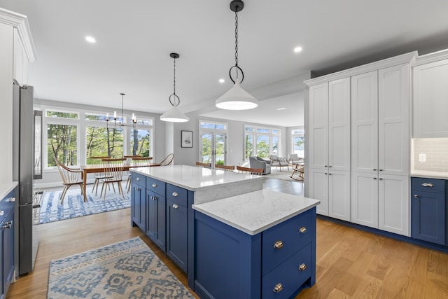 92 Brooks Cove Rd, Westport Island, ME 04578 - kitchen with blue cabinets, light wood finished floors, white cabinetry, healthy amount of natural light, and recessed lighting