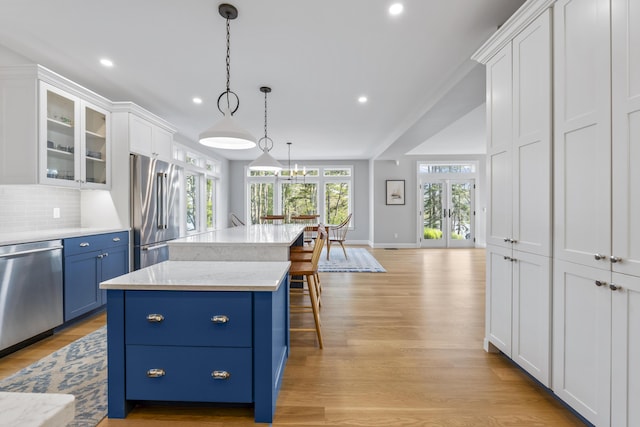 92 Brooks Cove Rd, Westport Island, ME 04578 - kitchen with appliances with stainless steel finishes, blue cabinets, french doors, white cabinets, and light wood-style flooring