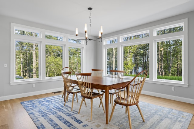 92 Brooks Cove Rd, Westport Island, ME 04578 - dining space featuring a chandelier and light wood-style flooring