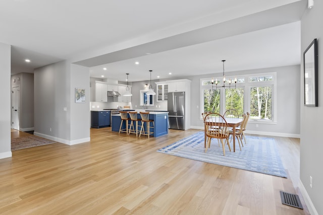 92 Brooks Cove Rd, Westport Island, ME 04578 - dining room with a chandelier, light wood finished floors, and recessed lighting