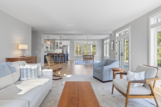 92 Brooks Cove Rd, Westport Island, ME 04578 - living area featuring light wood-type flooring and a chandelier