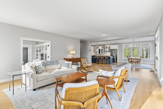 92 Brooks Cove Rd, Westport Island, ME 04578 - living area featuring light wood-type flooring and a chandelier