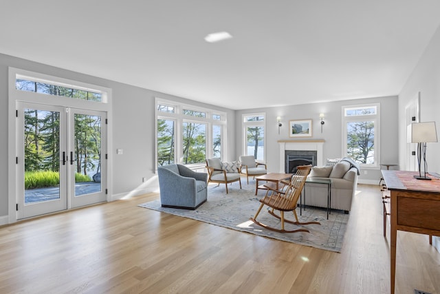 92 Brooks Cove Rd, Westport Island, ME 04578 - living area featuring a glass covered fireplace, plenty of natural light, and light wood-type flooring