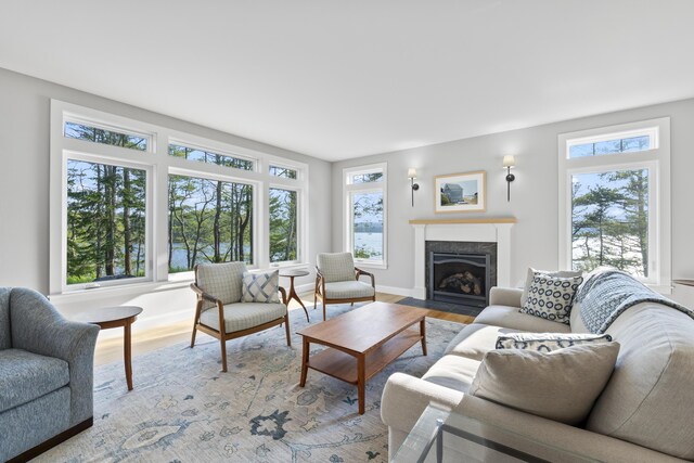 92 Brooks Cove Rd, Westport Island, ME 04578 - living room featuring healthy amount of natural light, a fireplace with flush hearth, and light wood-type flooring