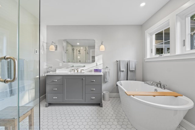 92 Brooks Cove Rd, Westport Island, ME 04578 - full bathroom featuring vanity, a freestanding tub, a shower stall, healthy amount of natural light, and recessed lighting