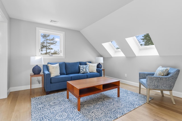92 Brooks Cove Rd, Westport Island, ME 04578 - living area with a skylight, wood finished floors, and vaulted ceiling