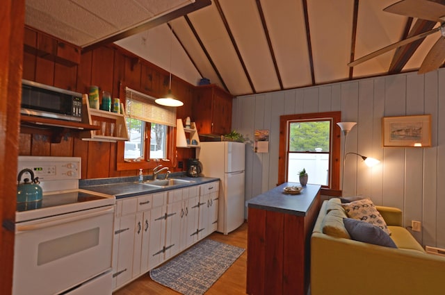 586 Kings Hwy Unit 2, Kennebunkport, ME 04046 - kitchen featuring white appliances, dark countertops, a sink, light wood-style floors, and lofted ceiling