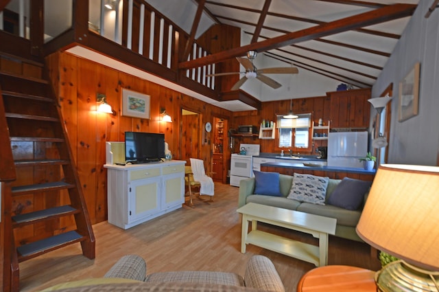 586 Kings Hwy Unit 2, Kennebunkport, ME 04046 - living room with wooden walls, a ceiling fan, high vaulted ceiling, light wood-type flooring, and beam ceiling