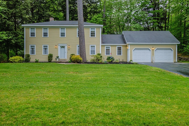 55 Evergreen Ln, Windham, ME 04062 - colonial home with a garage, asphalt driveway, a chimney, and a front lawn