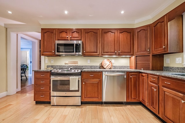 55 Evergreen Ln, Windham, ME 04062 - kitchen with stainless steel appliances, stone counters, light wood finished floors, crown molding, and recessed lighting