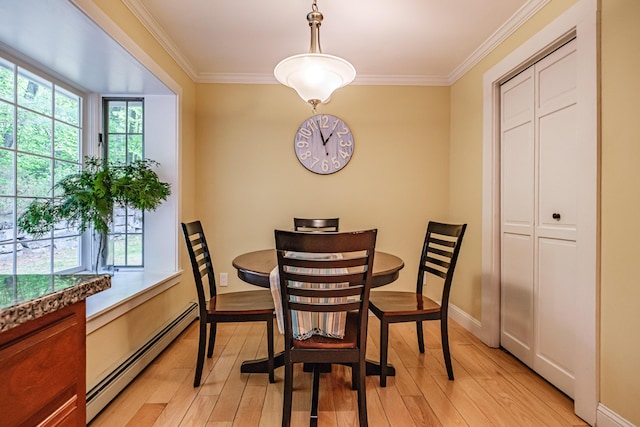 55 Evergreen Ln, Windham, ME 04062 - dining room with a baseboard heating unit, crown molding, light wood-style flooring, and baseboards
