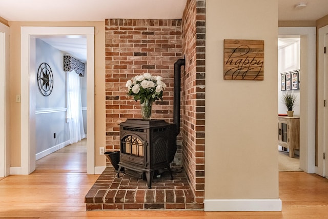 55 Evergreen Ln, Windham, ME 04062 - detailed view of wood finished floors, baseboards, a wood stove, and a smoke detector