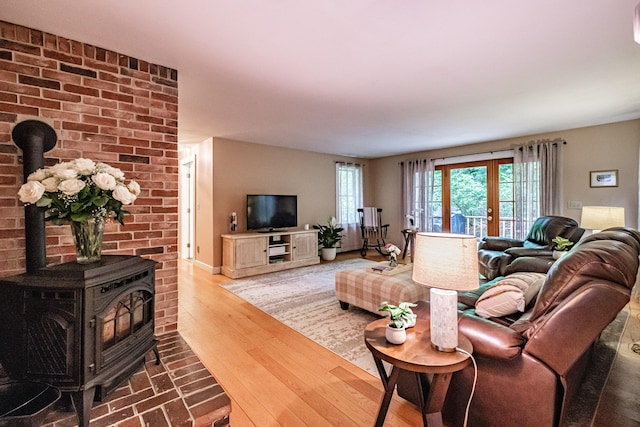 55 Evergreen Ln, Windham, ME 04062 - living area with a wood stove, wood finished floors, and baseboards