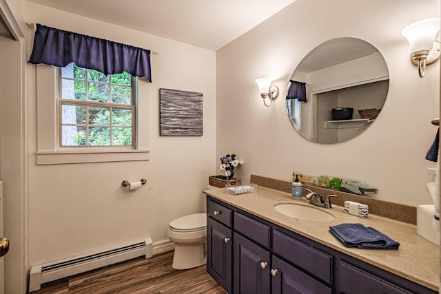 55 Evergreen Ln, Windham, ME 04062 - bathroom with a baseboard radiator, toilet, wood finished floors, vanity, and baseboards