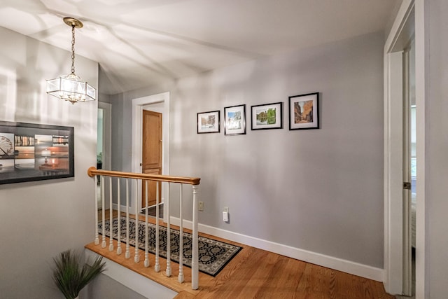 55 Evergreen Ln, Windham, ME 04062 - hall featuring an upstairs landing, a chandelier, baseboards, and wood finished floors