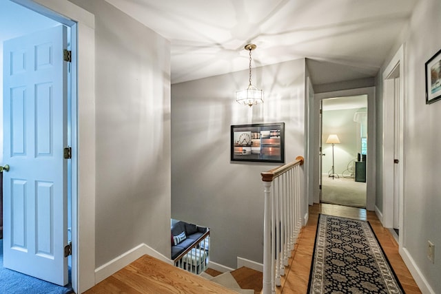 55 Evergreen Ln, Windham, ME 04062 - hall with an upstairs landing, light wood-style flooring, baseboards, and a chandelier