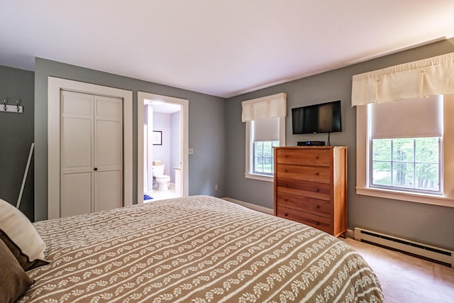 55 Evergreen Ln, Windham, ME 04062 - carpeted bedroom with a baseboard radiator, a closet, ensuite bath, and baseboards