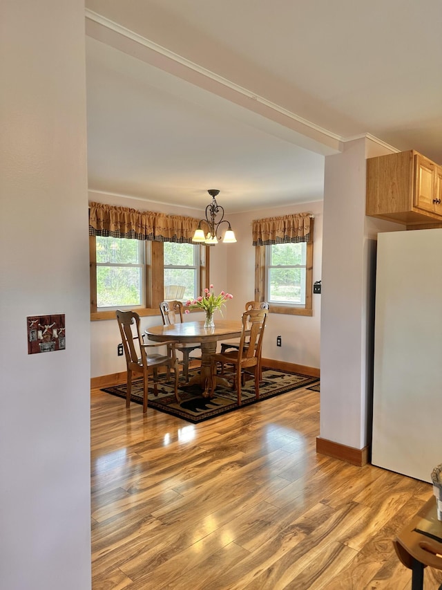 53 Branch Brook Ln, Newfield, ME 04095 - dining space with light wood finished floors, baseboards, a chandelier, and crown molding