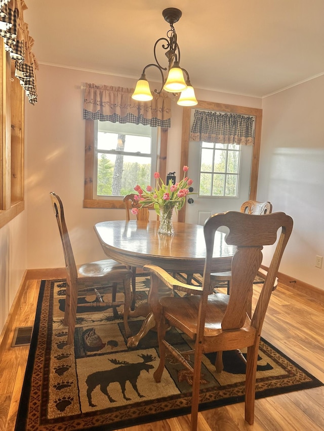 53 Branch Brook Ln, Newfield, ME 04095 - dining space featuring healthy amount of natural light, wood finished floors, and ornamental molding
