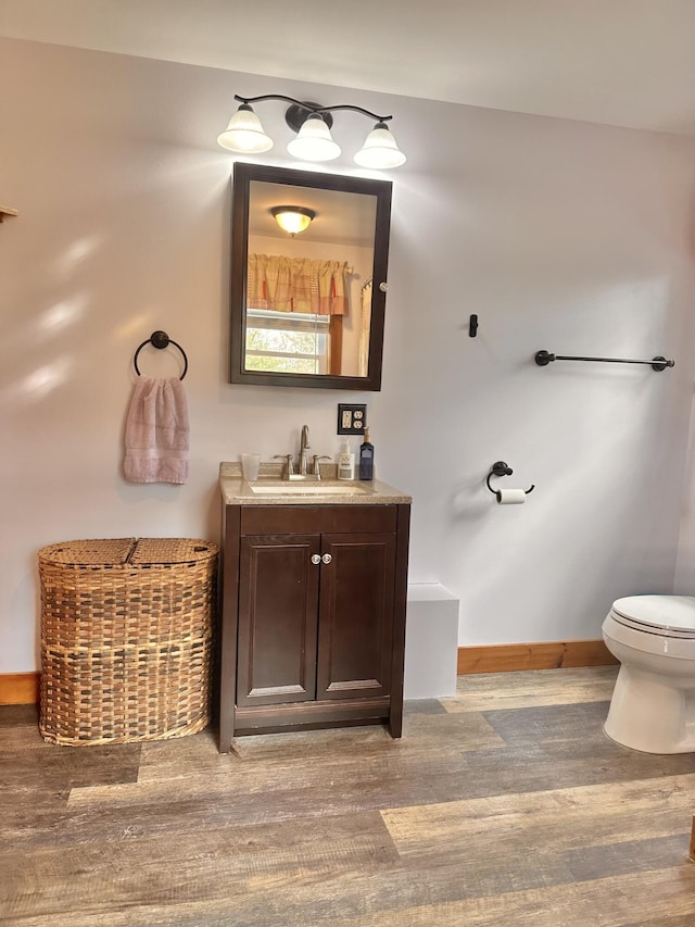 53 Branch Brook Ln, Newfield, ME 04095 - bathroom with wood finished floors, vanity, toilet, and baseboards