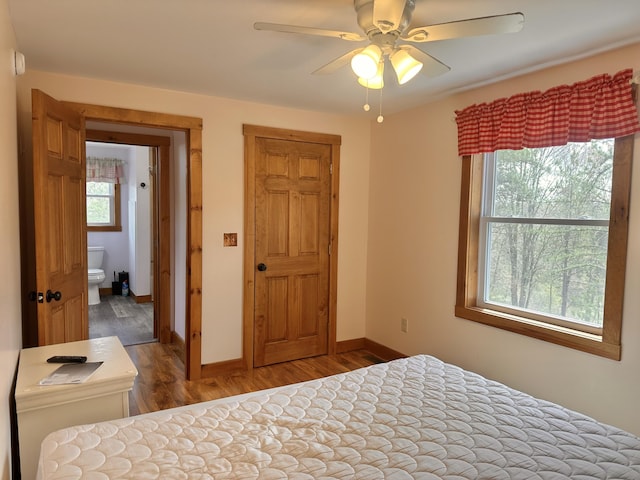 53 Branch Brook Ln, Newfield, ME 04095 - bedroom with wood finished floors, baseboards, a ceiling fan, and connected bathroom