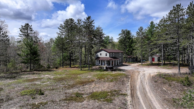 53 Branch Brook Ln, Newfield, ME 04095 - view of dirt / gravel driveway with a forest view