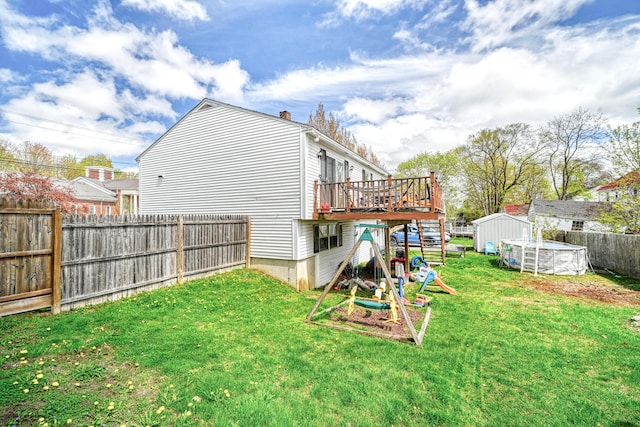 back of house with a deck, a storage unit, an outdoor structure, and a chimney