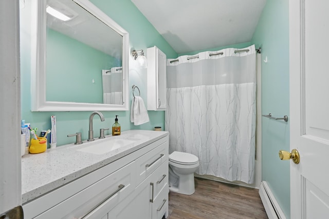 bathroom with baseboard heating, wood finished floors, vanity, toilet, and shower / bath combination with curtain