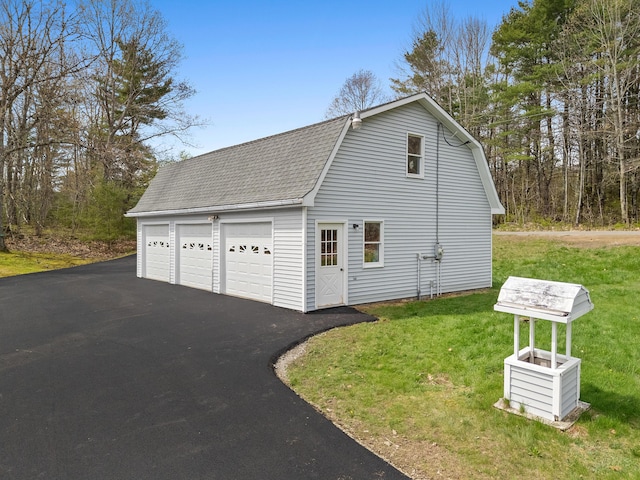 289 W Washington Rd, Washington, ME 04574 - view of side of property featuring a shingled roof, a garage, an outbuilding, a gambrel roof, and a yard