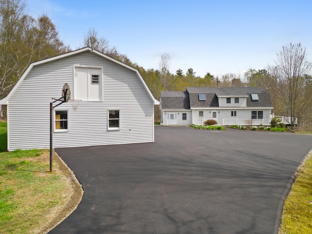 289 W Washington Rd, Washington, ME 04574 - colonial inspired home with a gambrel roof, asphalt driveway, and a shingled roof
