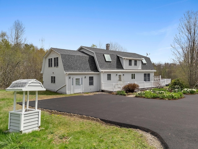 289 W Washington Rd, Washington, ME 04574 - dutch colonial featuring a shingled roof, a chimney, a gambrel roof, and a deck