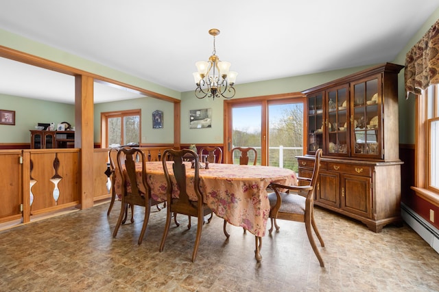 289 W Washington Rd, Washington, ME 04574 - dining space featuring a wainscoted wall, a chandelier, a baseboard heating unit, and wooden walls