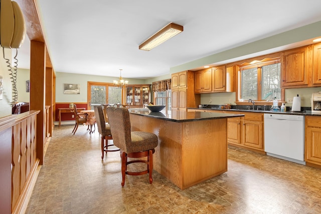 289 W Washington Rd, Washington, ME 04574 - kitchen with dishwasher, a breakfast bar area, a kitchen island, a sink, and a chandelier