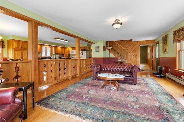 289 W Washington Rd, Washington, ME 04574 - living area featuring light wood-style flooring, wooden walls, stairs, and a wainscoted wall
