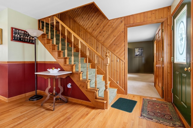 289 W Washington Rd, Washington, ME 04574 - entryway with stairway, wooden walls, baseboards, and wood finished floors