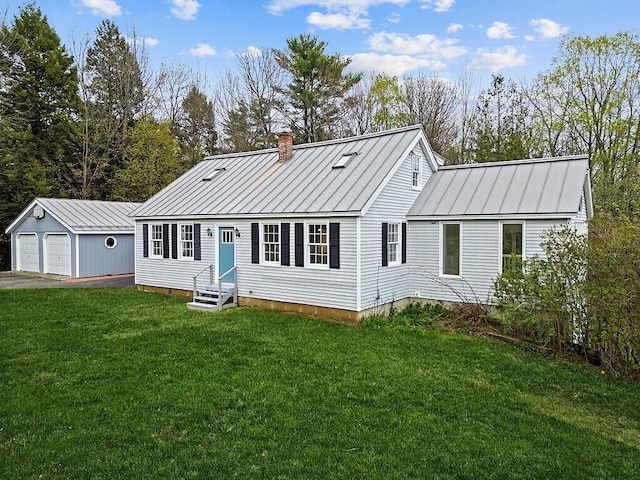 view of front of property featuring entry steps, a garage, an outdoor structure, a standing seam roof, and metal roof