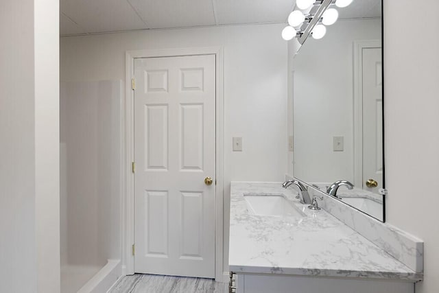 bathroom with vanity and a shower