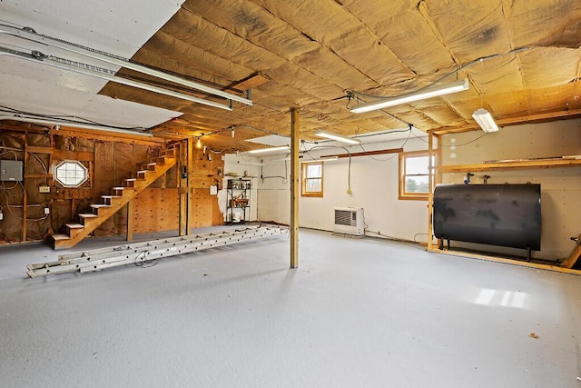 below grade area featuring oil tank and stairs