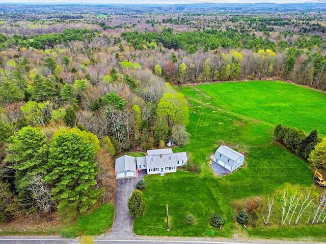 view from above of property with a heavily wooded area