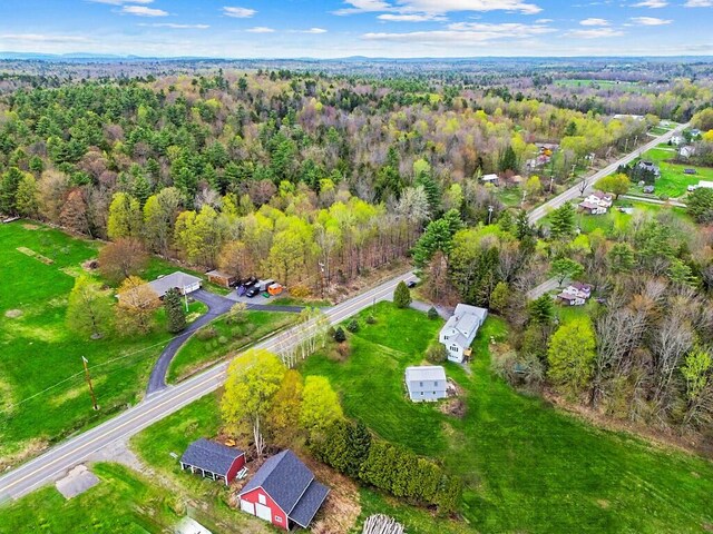 view of property location with a forest