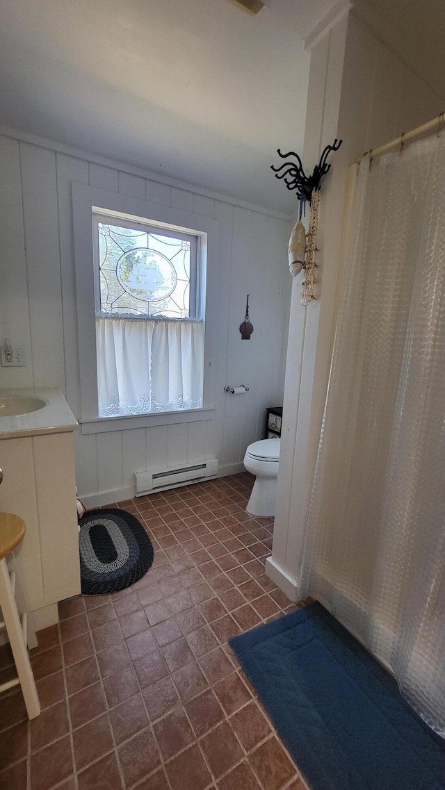 6 Glenmere Rd, Saint George, ME 04860 - bathroom with a baseboard heating unit, a decorative wall, toilet, vanity, and curtained shower