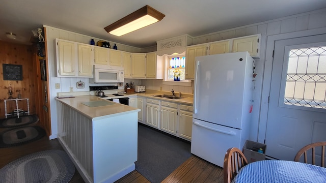 6 Glenmere Rd, Saint George, ME 04860 - kitchen featuring white appliances, a sink, light countertops, a peninsula, and wood walls