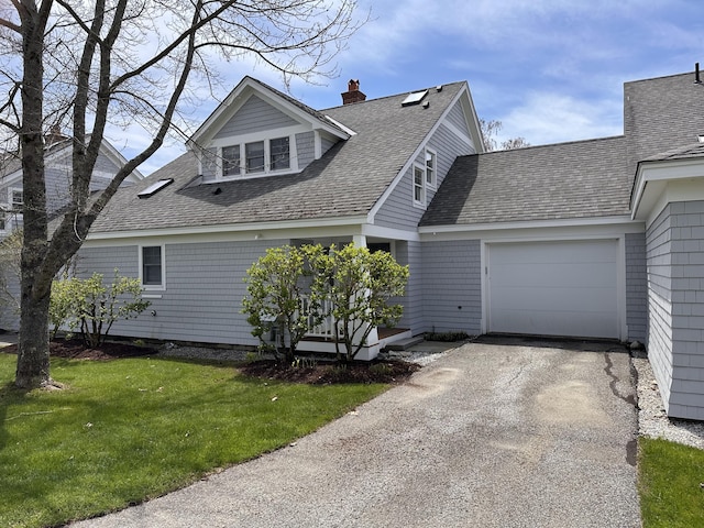 54 Village Way Unit 54, Rockport, ME 04856 - view of front of house with a garage, a shingled roof, a front yard, and a chimney