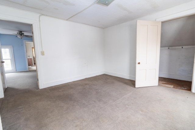 unfurnished bedroom featuring carpet floors, baseboards, ceiling fan, and a closet